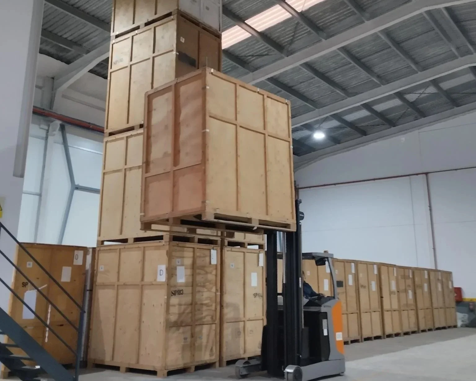 A forklift moving wooden storage containers inside our secure Algeciras warehouse