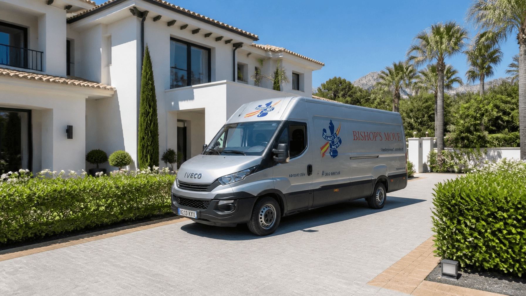 A silver Bishop's Move removals van parked outside a beautiful property in the Spanish sunshine