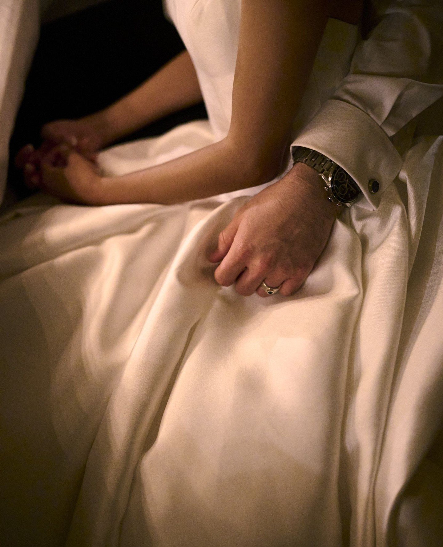 During dinner at Ch&acirc;teau de Vallery, the bride&rsquo;s father speaks, his voice soft, trembling with love. She listens, still, held by her husband&rsquo;s quiet embrace. No words, no pose, just this intimate gesture under the warm candlelight.⁠