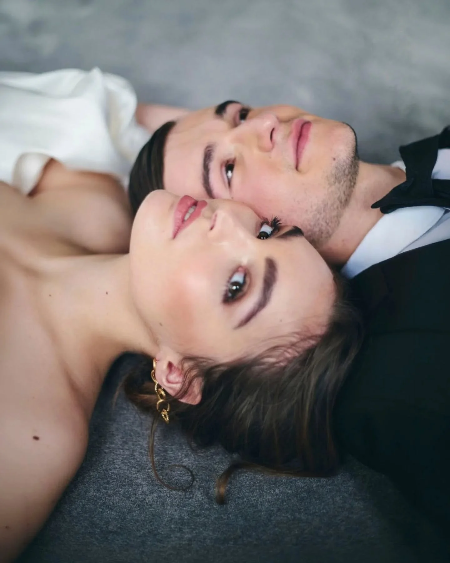 The morning begins quietly. Soft light, white sheets, skin against fabric. A pause before everything shifts.

Then structure takes over. A sculptural gown. A black tuxedo. Marble, molding, clean Parisian lines.

Preparation becomes part of the aesthe