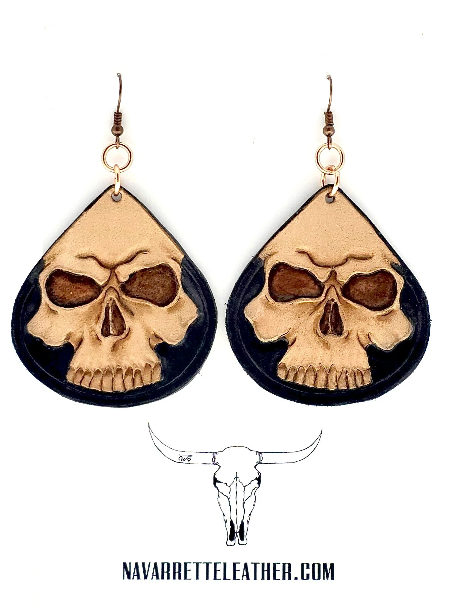 Tooled skull earring with black background