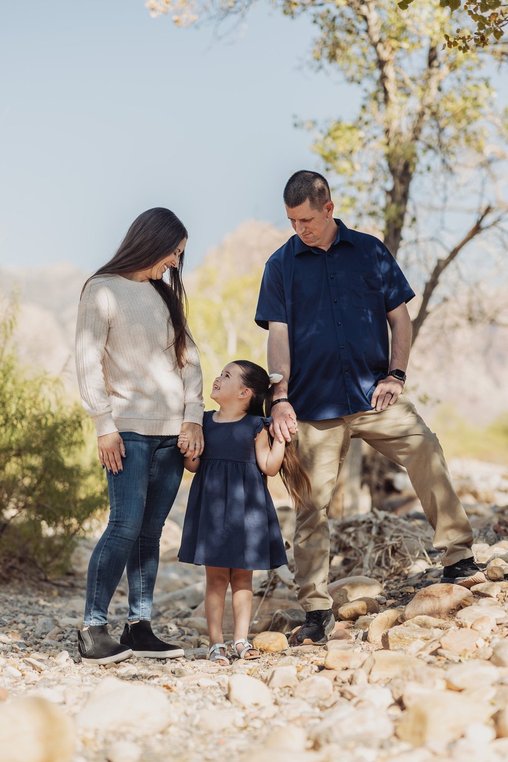 Family photographed beside a sandstone boulder in Calico Basin near Red Rock Canyon