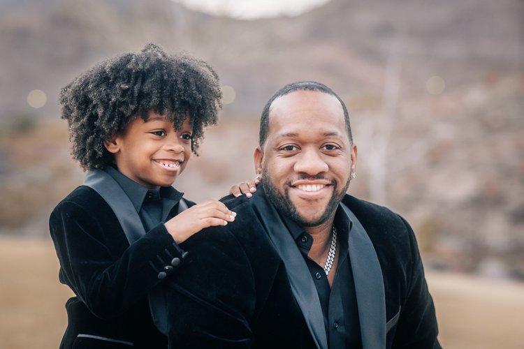 Father and son laughing together during a Henderson family session