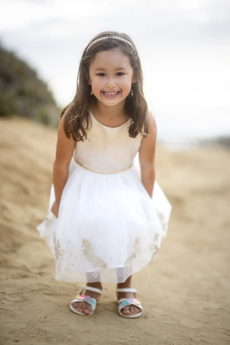 Young girl smiling during a playful outdoor portrait session