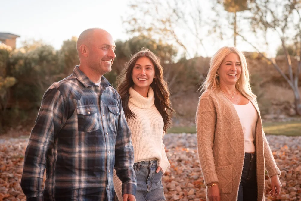 Family of three walking together during a relaxed Las Vegas portrait session