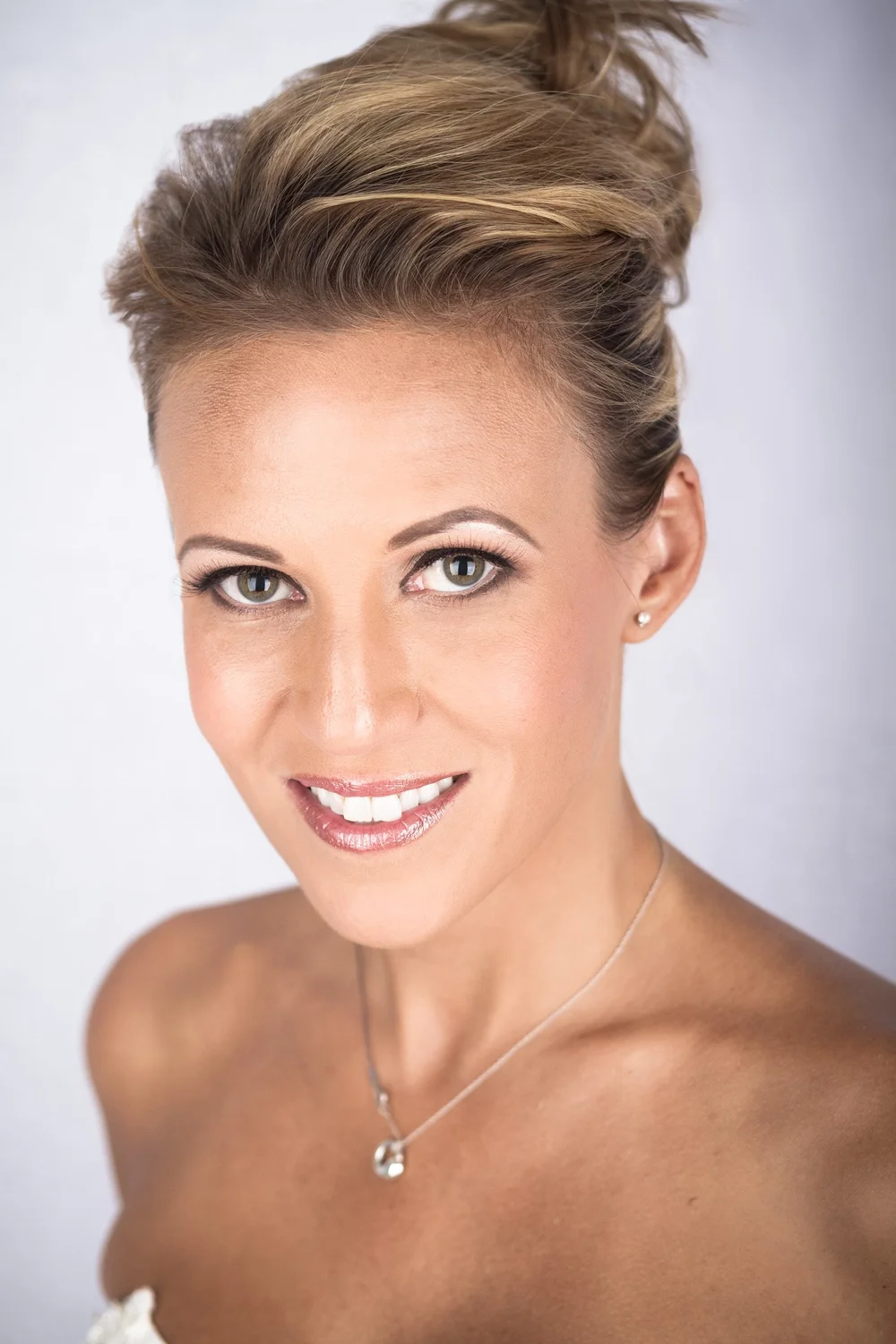 Studio headshot of a woman photographed on a dark background in Las Vegas