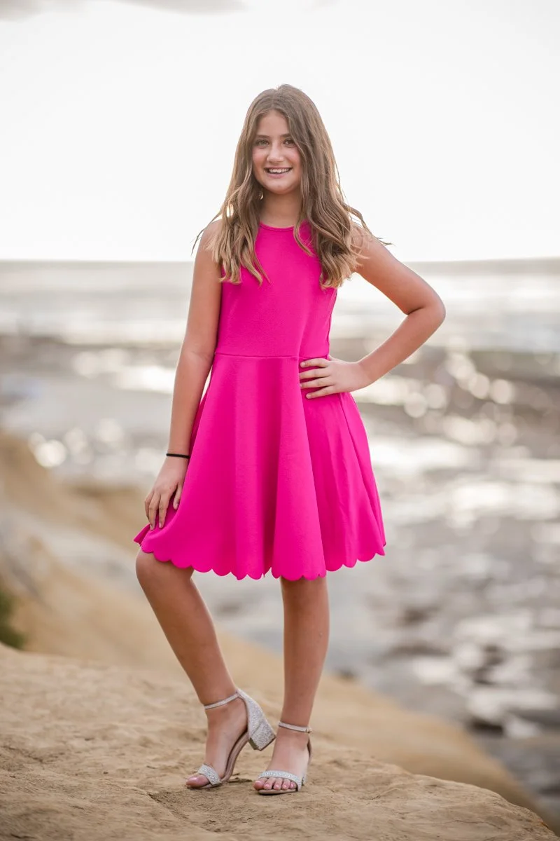 Girl posing confidently above the ocean during a portrait session