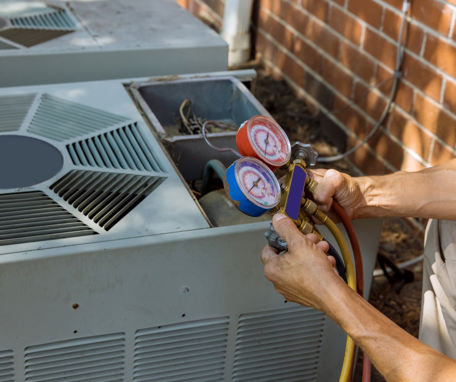 Technician working on HVAC unit outside in snowy weather, inspecting copper piping and electrical components.