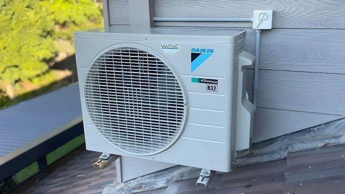 Outdoor air conditioning unit installed on the exterior wall of a building.