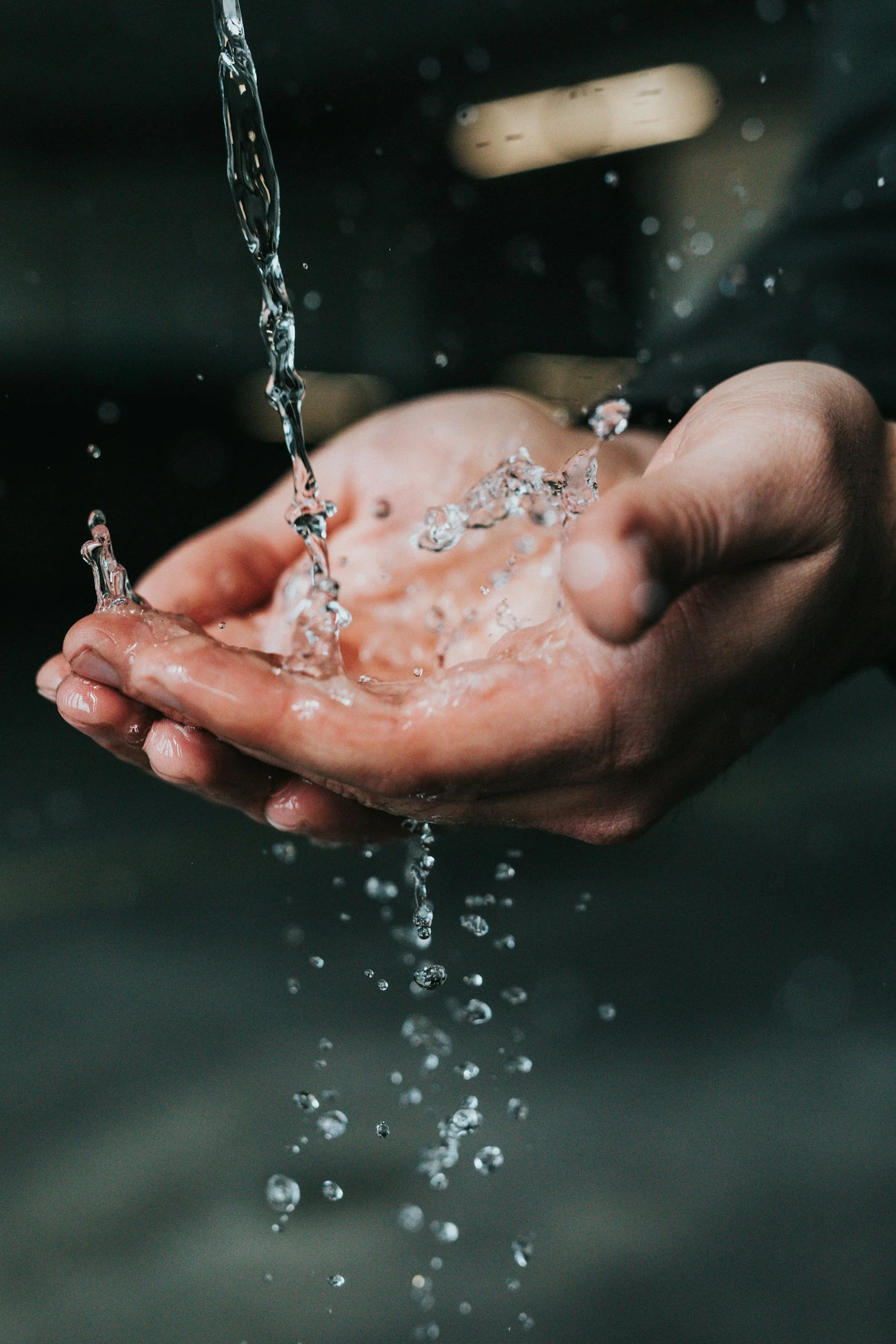 water dripping into someone's hands