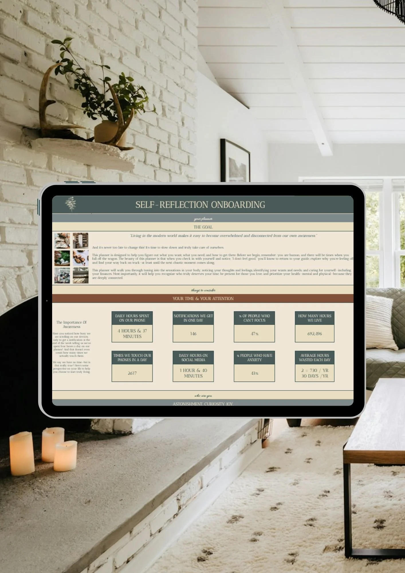 An iPad displaying a Self-reflection-bullet-journal in a living room with white brick walls, candles, and a carpet.