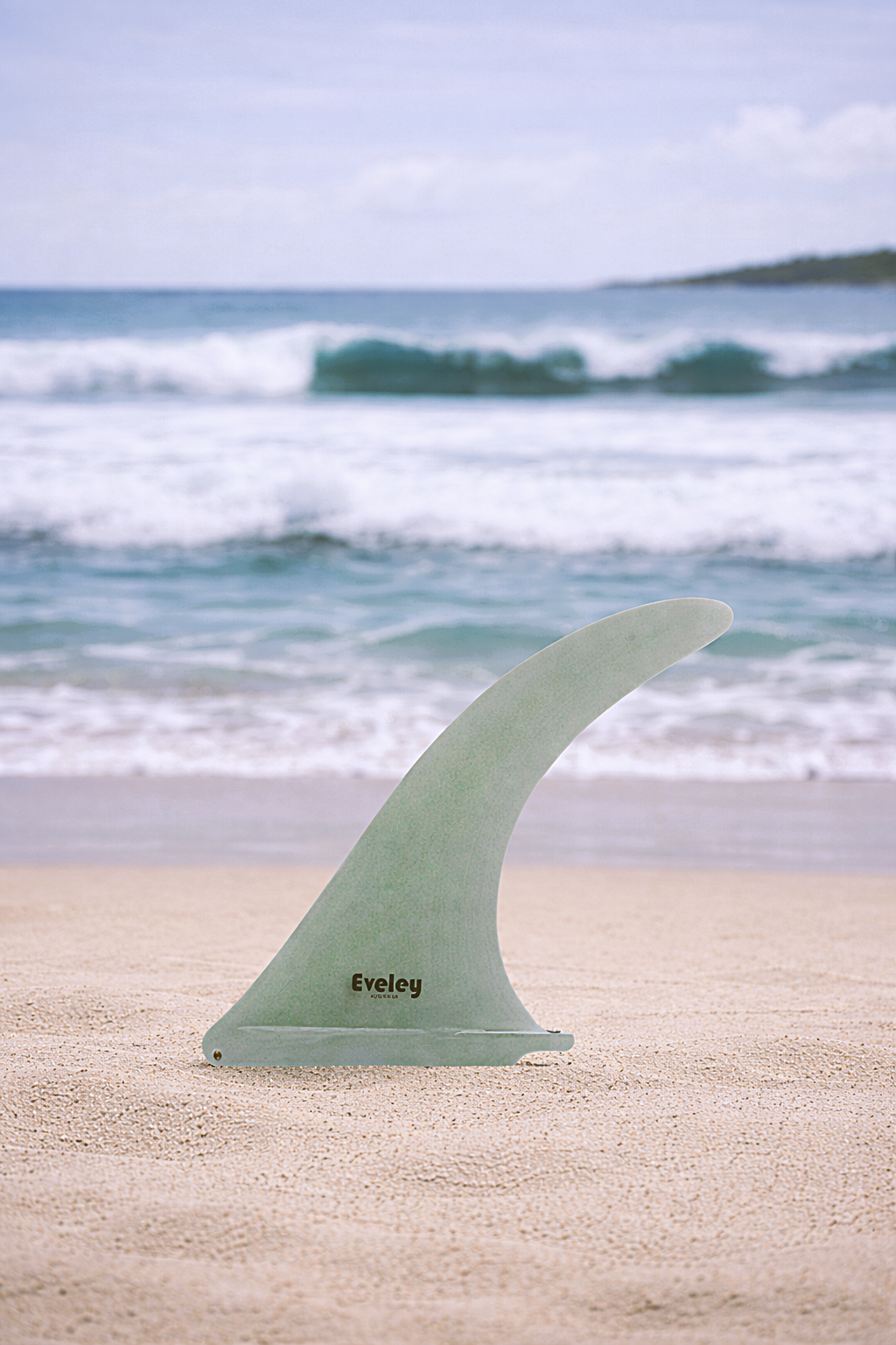 Eveley 10.75 inch Funky Monkey natural Pro Glass longboard fin on beach – premium surfboard fins and longboard fins for classic surfing performance.