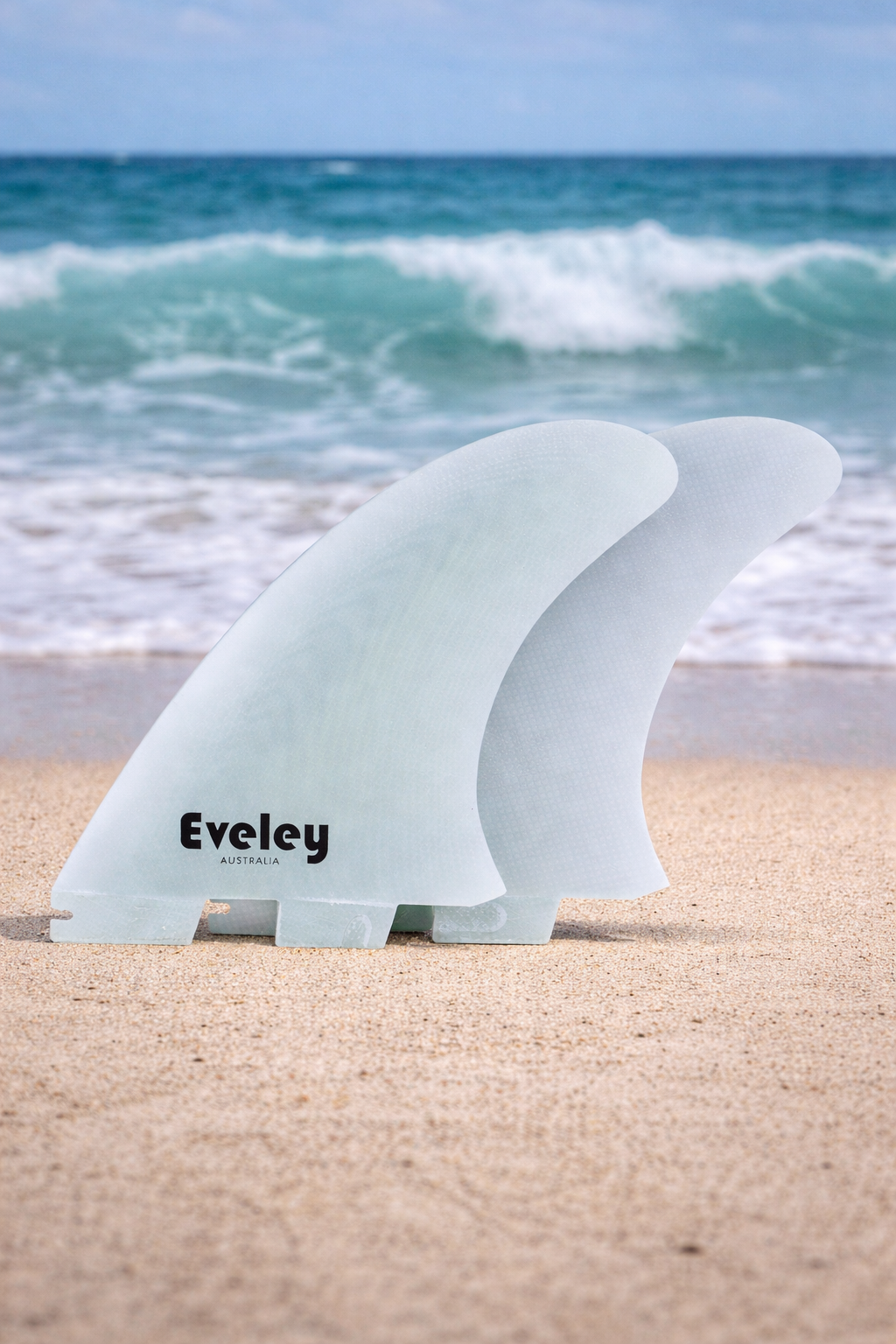 Side view of natural Pro Glass upright twin fins showing classic outline and fiberglass texture.