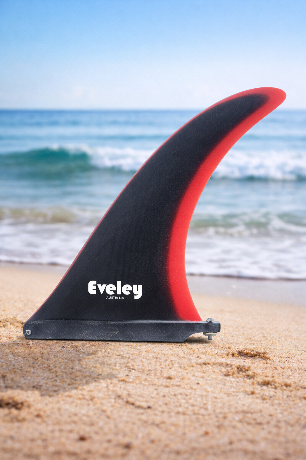 International 4A longboard fin with black on red colour on  a beach