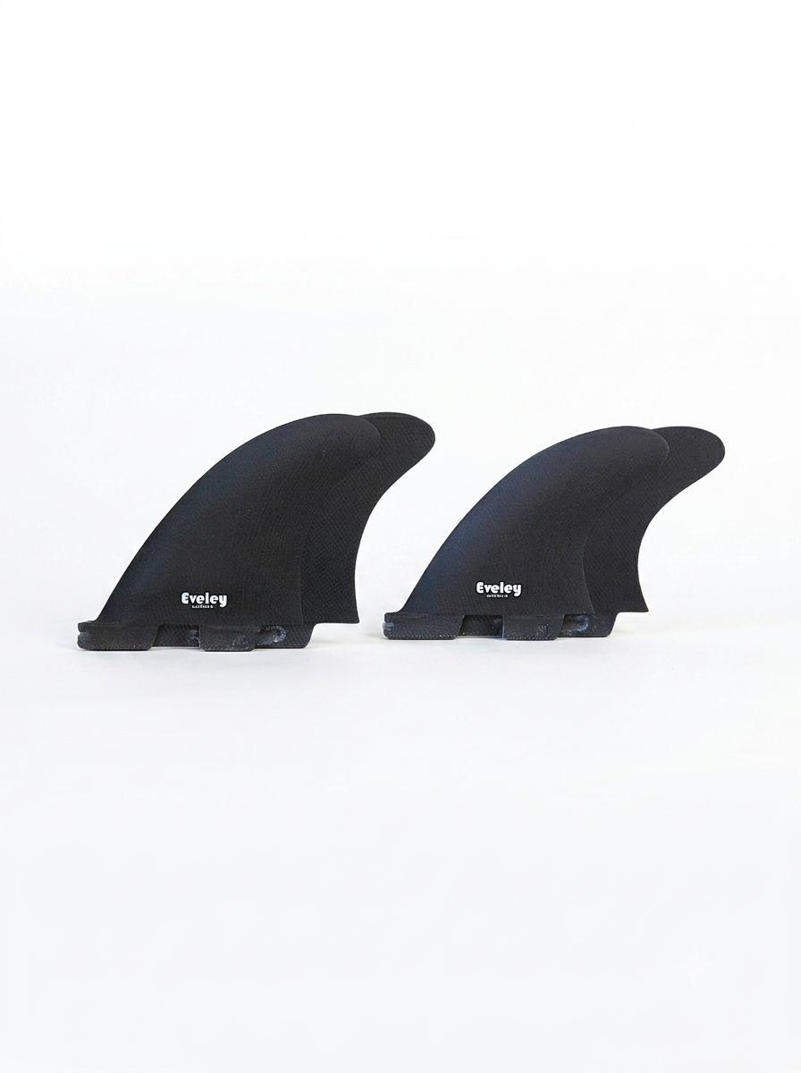 Set of four black Eveley Pro Glass quad surfboard fins with 4.7-inch front fins and 4.2-inch rear fins for FCSII fin plugs