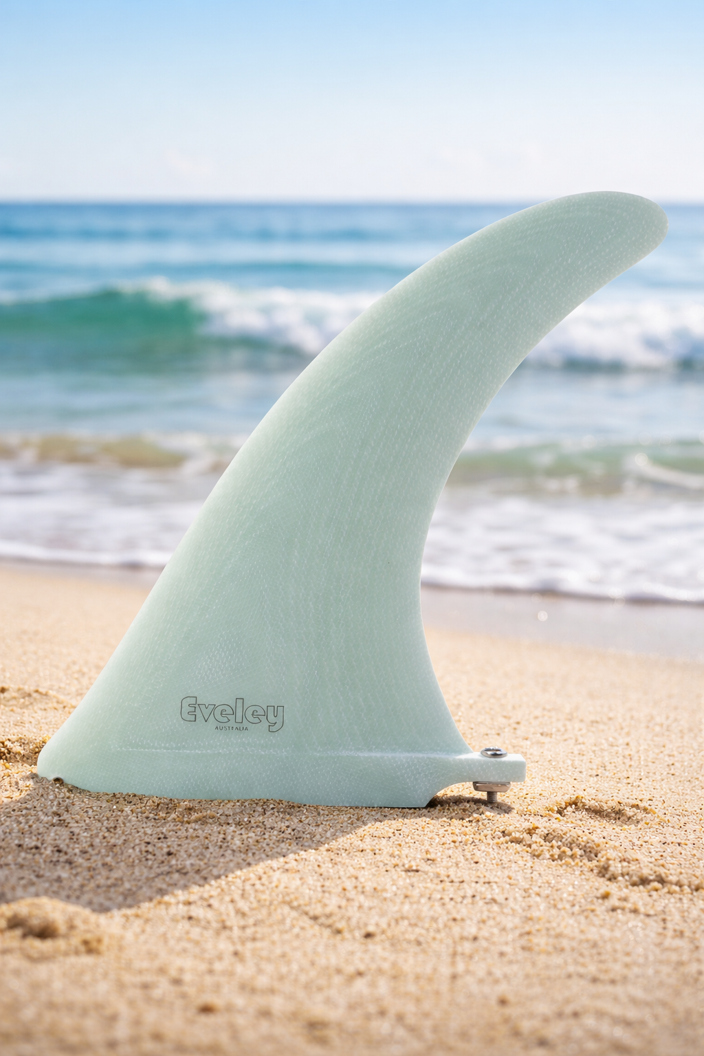Eveley 9 inch International 4A longboard center fin in Volan fiberglass on a beach