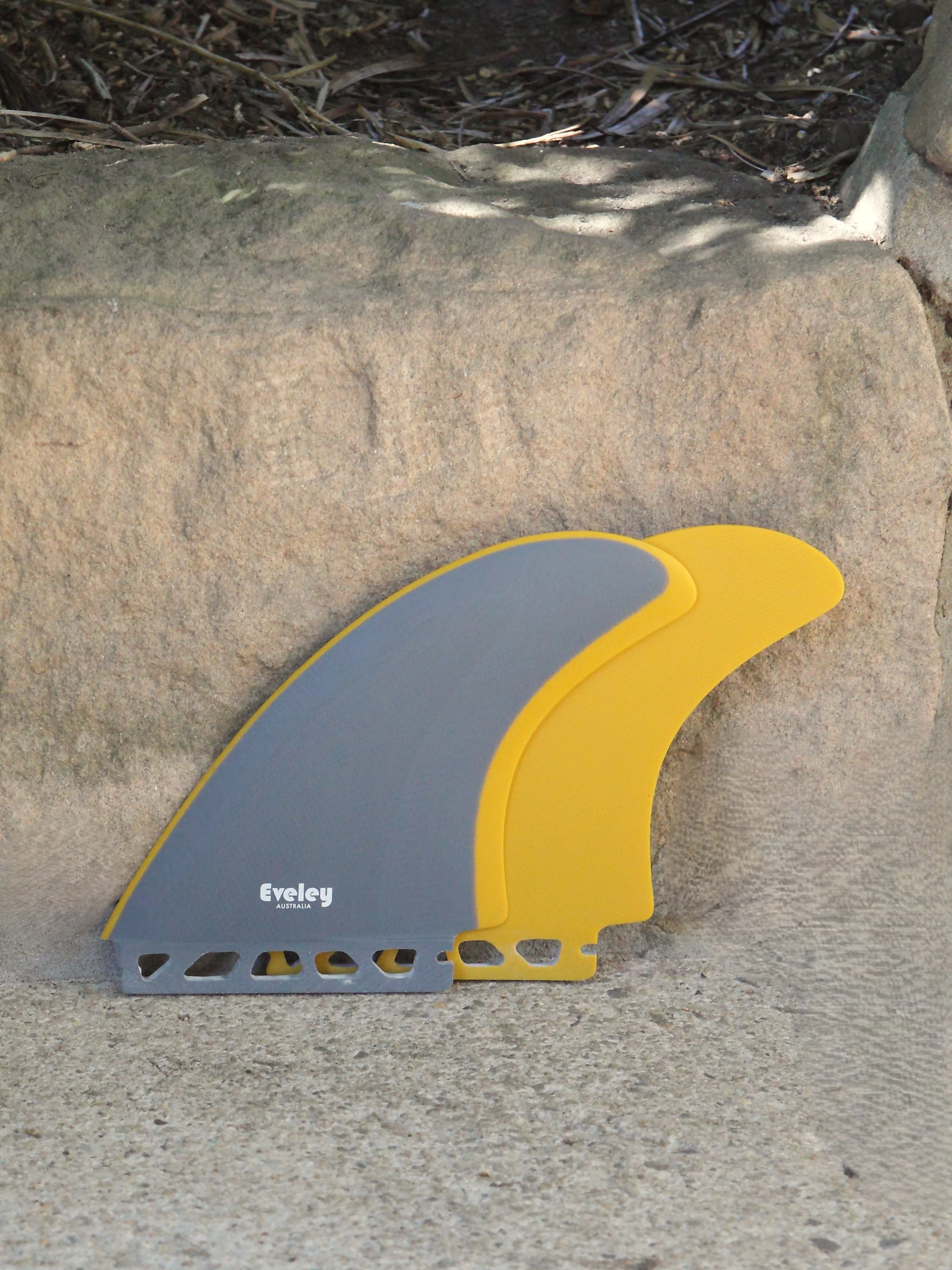 Pair of grey and mustard Eveley fins for a Futures compatible twin-fin surfboard