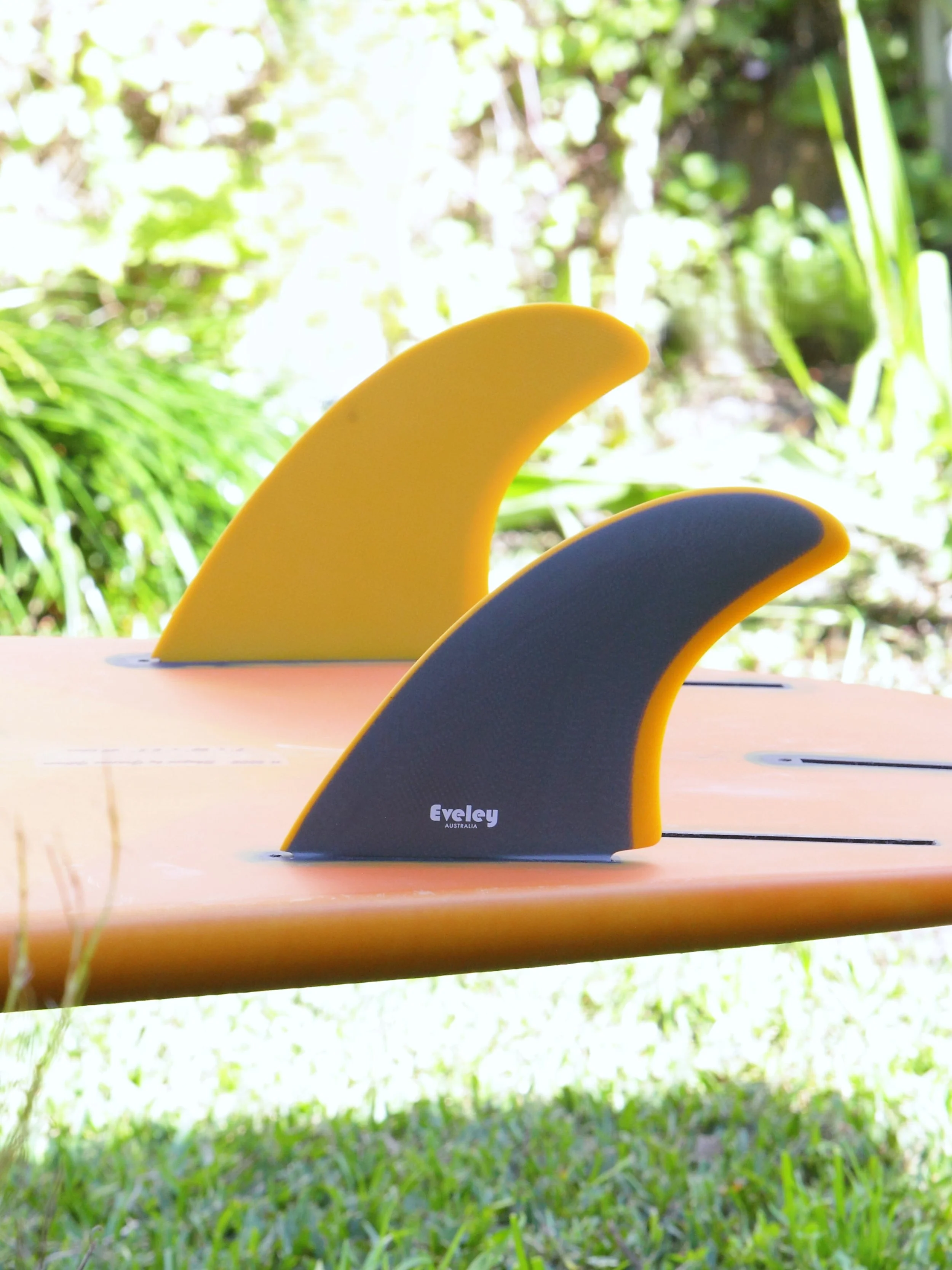 Grey and mustard Pro Glass construction on an Eveley 5.5-inch twin surfboard fin