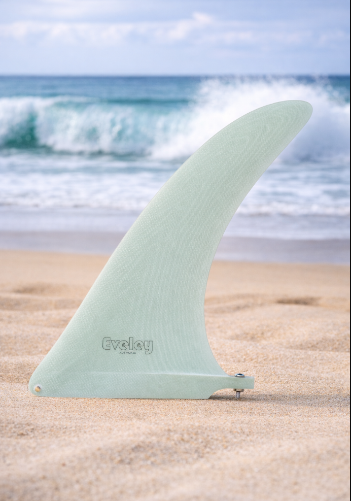 10.5" Logger Center Fin – Volan Pro Glass Longboard Fin on a beach