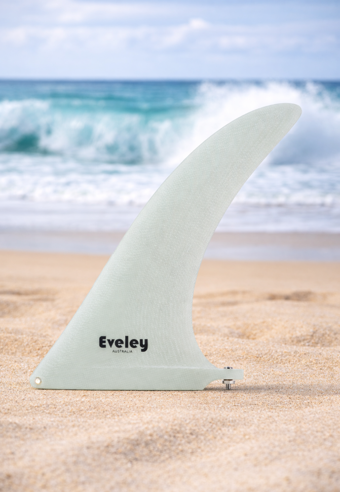 10" Pivot Center Fin – Volan Pro Glass Longboard Fin on a beach