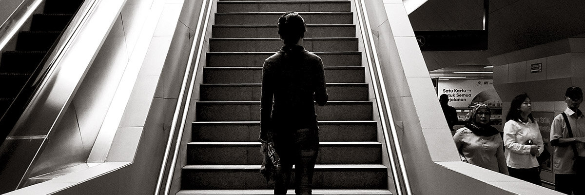 Man looking up at staircase