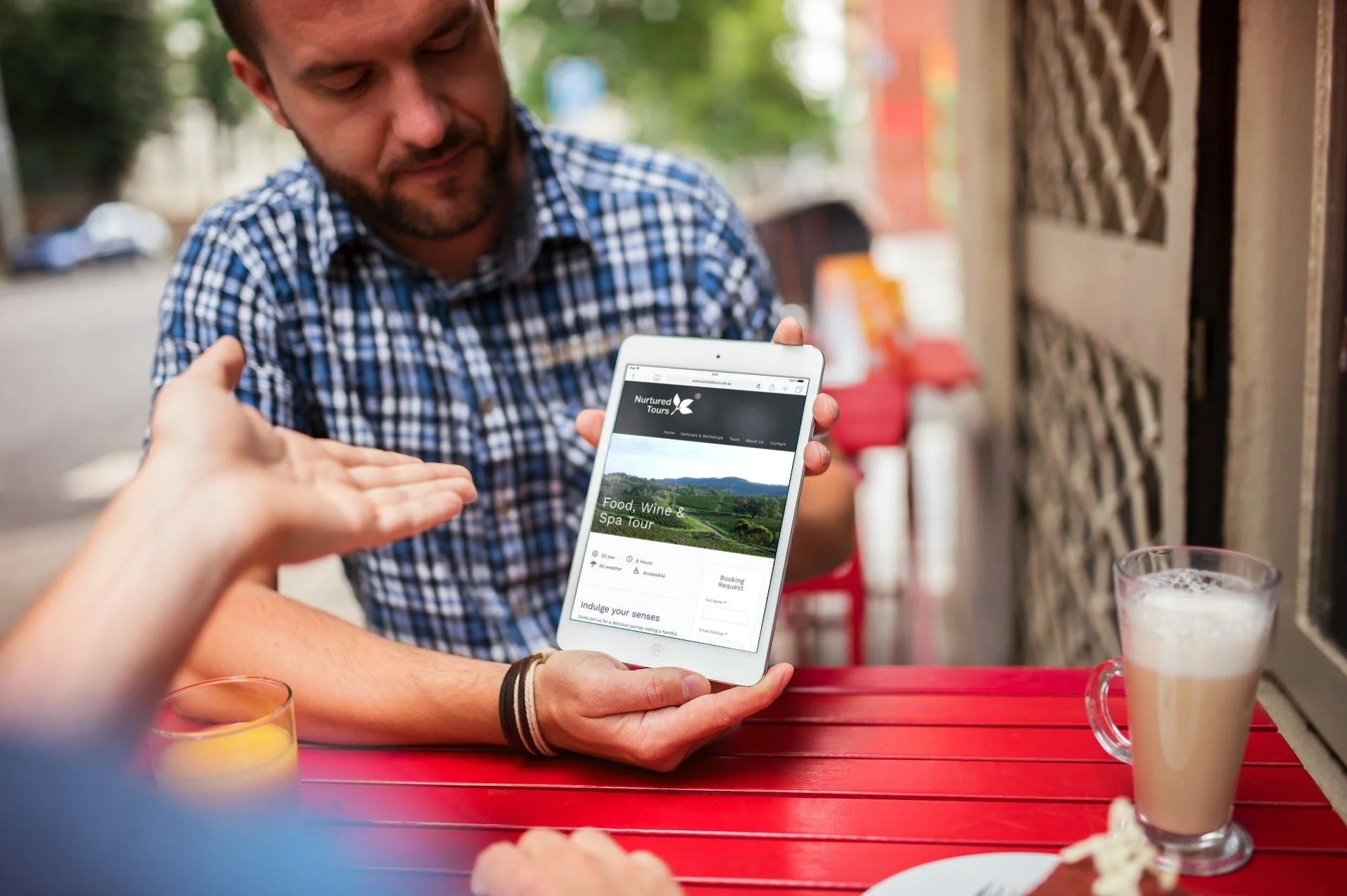 iPad Mini in the hands of a man during the meeting_Food, Wine & Spa Tours_Nurtured Tours.jpg