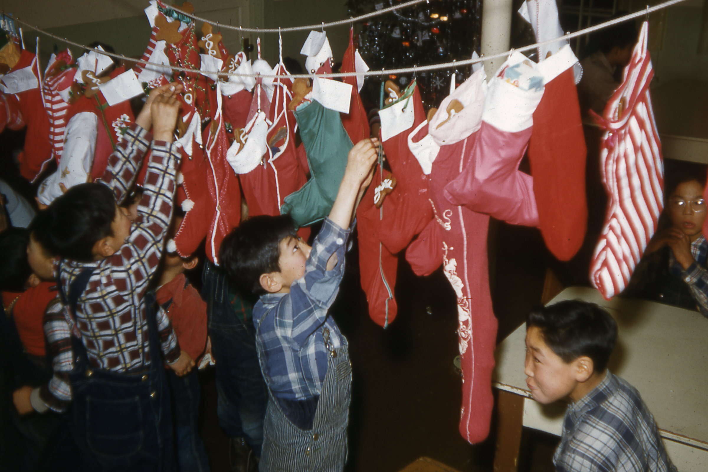  1955 Taking down Christmas stockings. Photo on loan from the Henkelman Archives.    