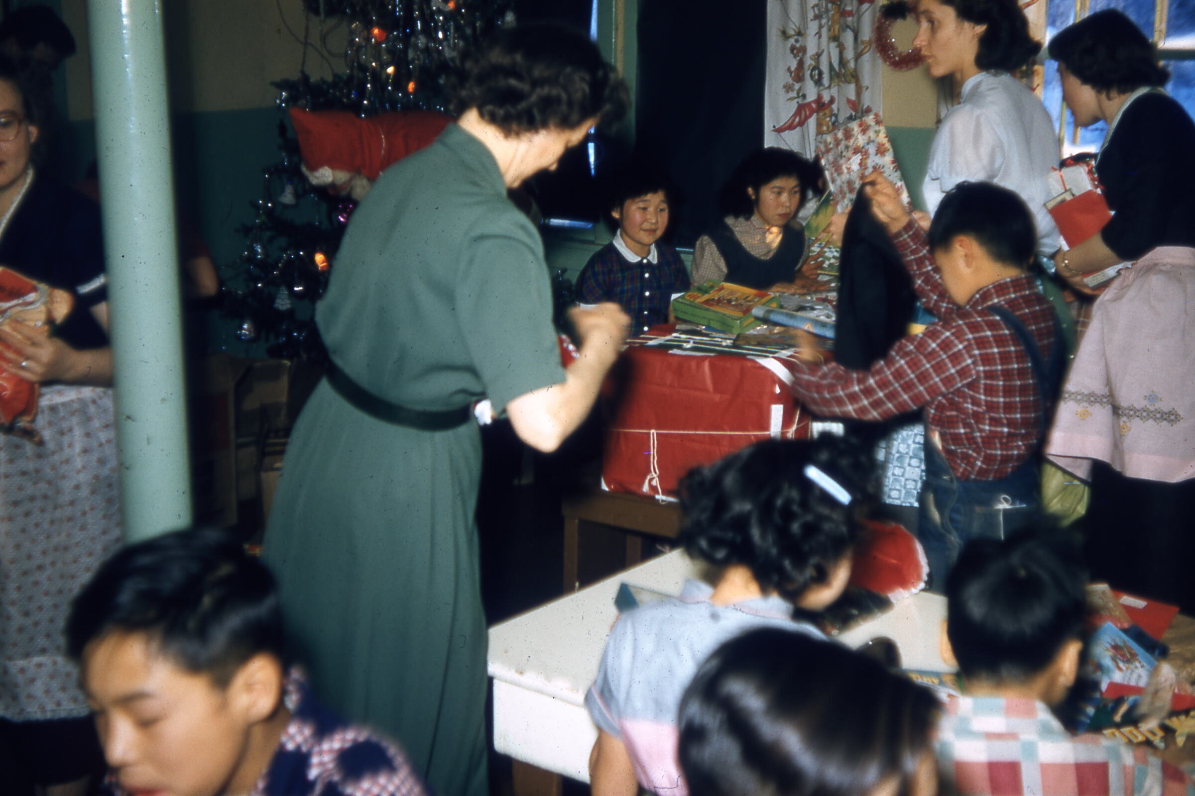  1957 Handing out gifts. Photo on loan from the Henkelman Archives. 