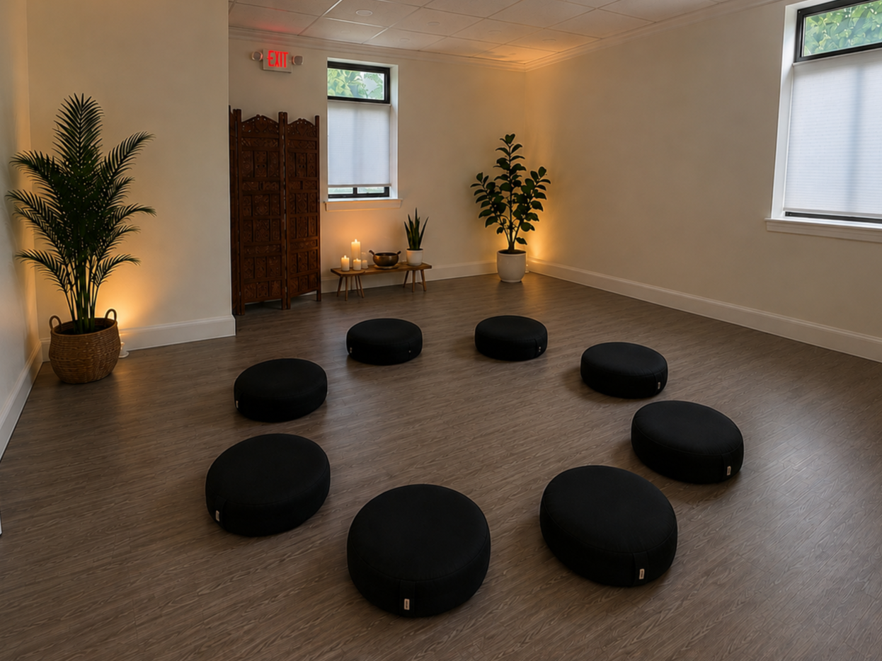 Community group space with meditation cushions on the floor.