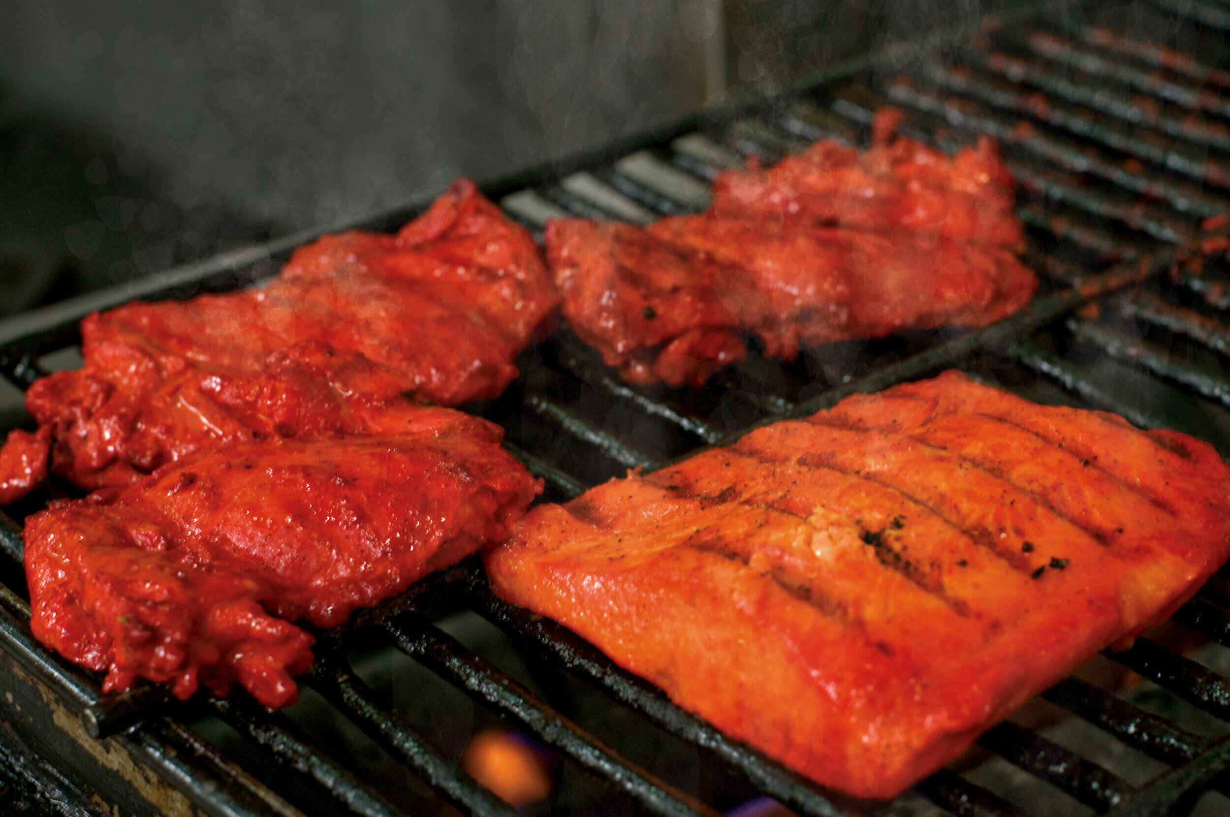 Chicken Tikka and Salmon happily grilling together. (Copy)