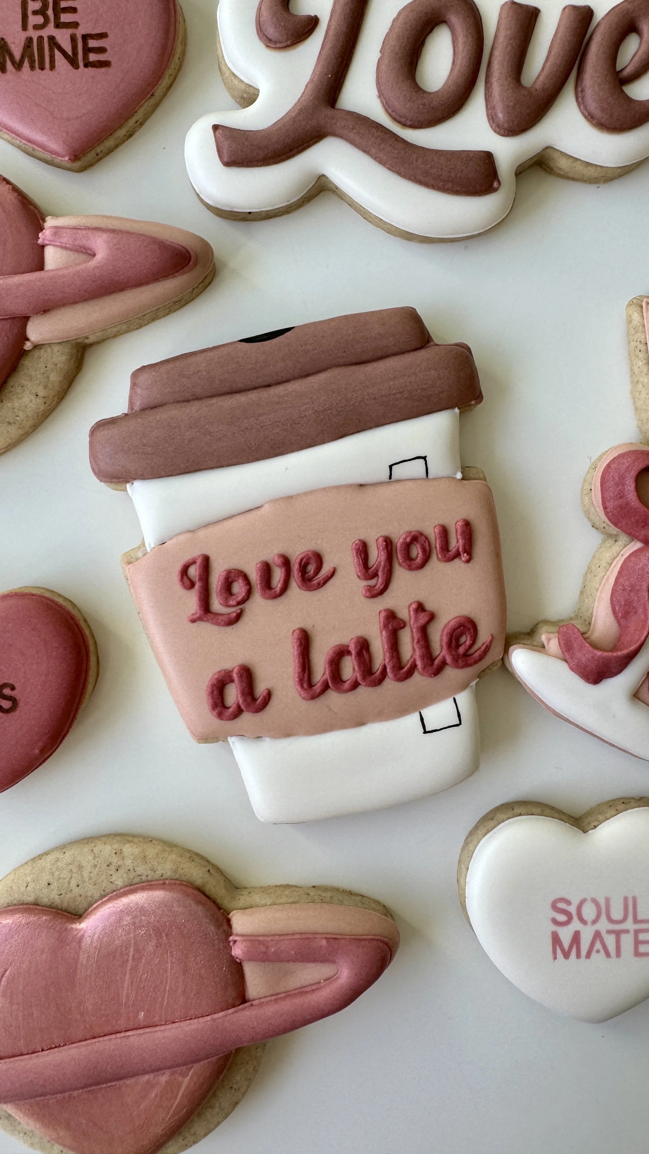 Valentine's Day themed cookies featuring a Starbucks style coffee cup that reads 'Love You a Latte'