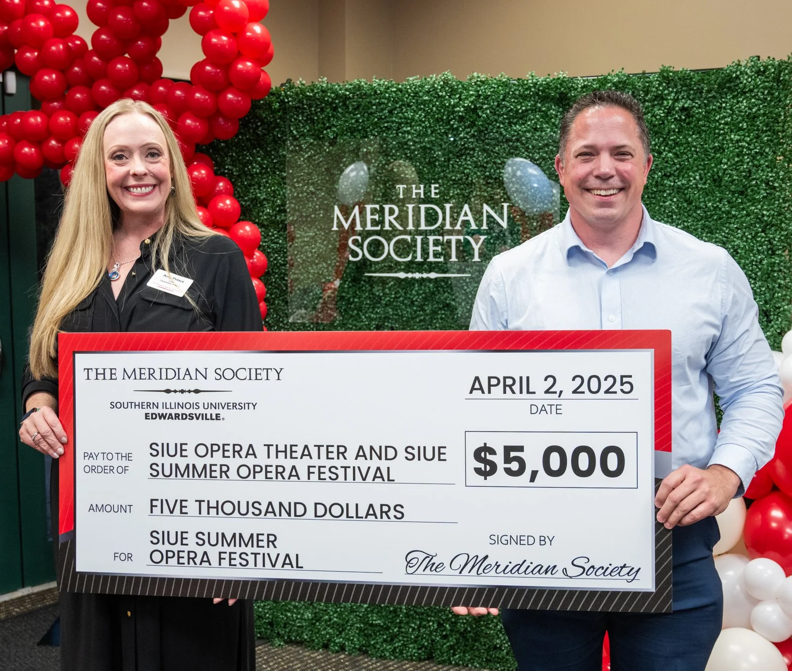 Amy Prince of Tessitura Music and Marc Schapman, Chair of the Music Department at Southern Illinois University Edwardsville accept the $5,000 Meridian Award from members of the Meridian Society.
