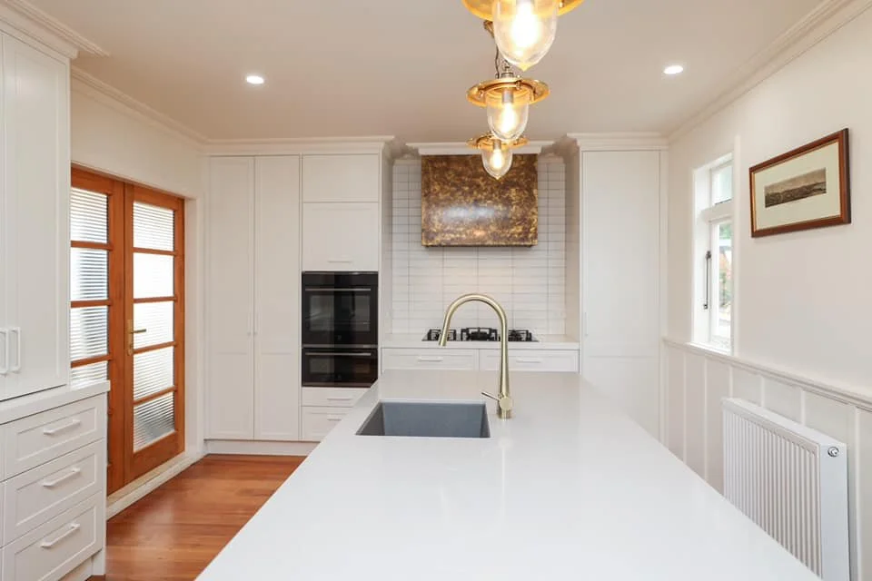 Contrasting white and brown kitchen renovation with gold brass tap  in Taranaki New Plymouth 