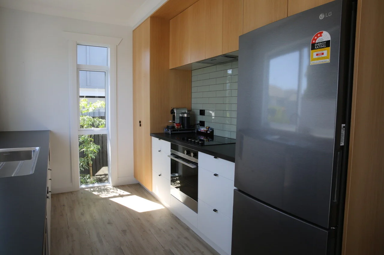 U Shaped kitchen renovation with timber floors and floor to ceiling storage in Taranaki New Plymouth