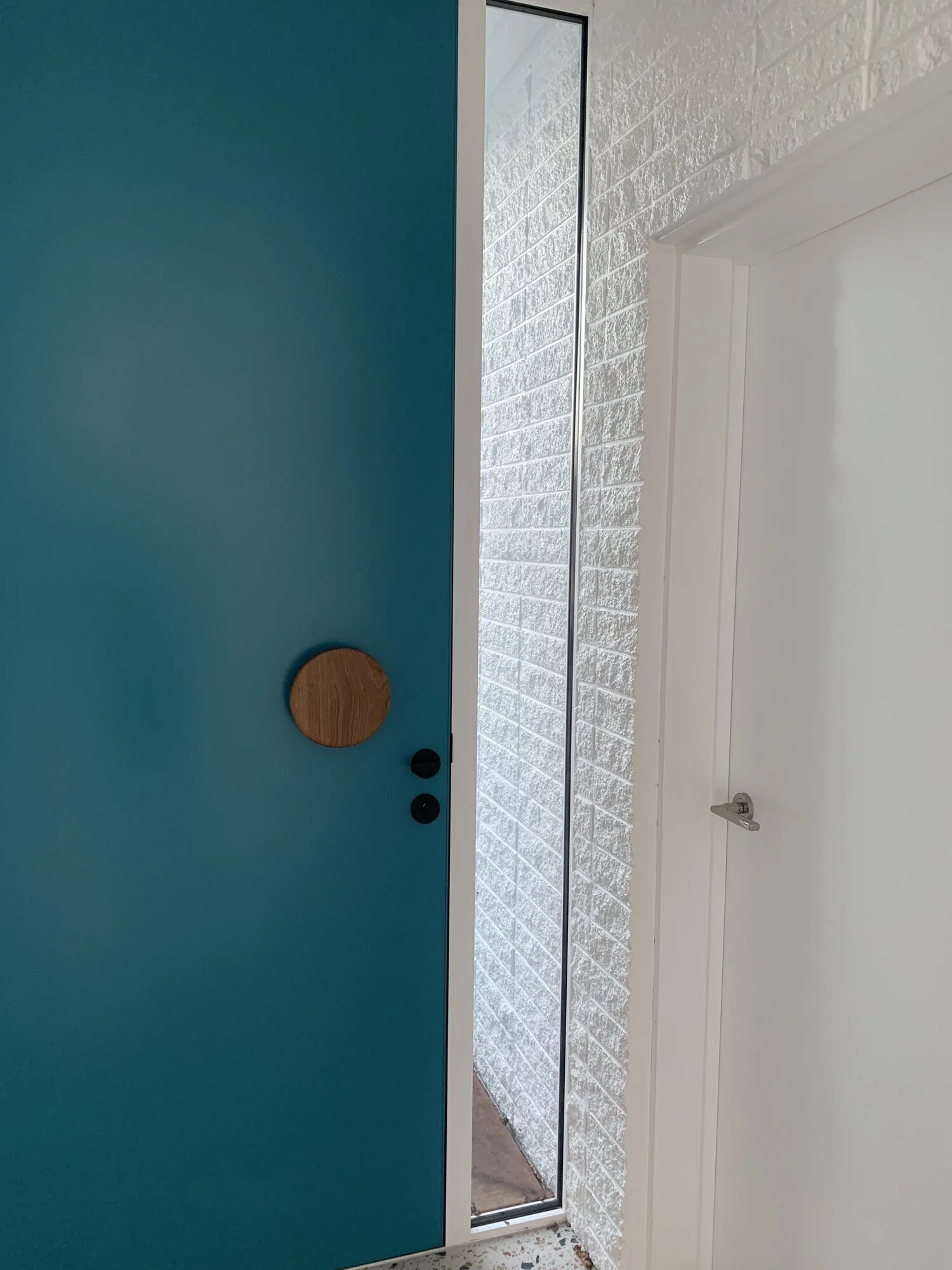 Renovated home making use of oversized entrance door and a splash of colour in Taranaki New Plymouth