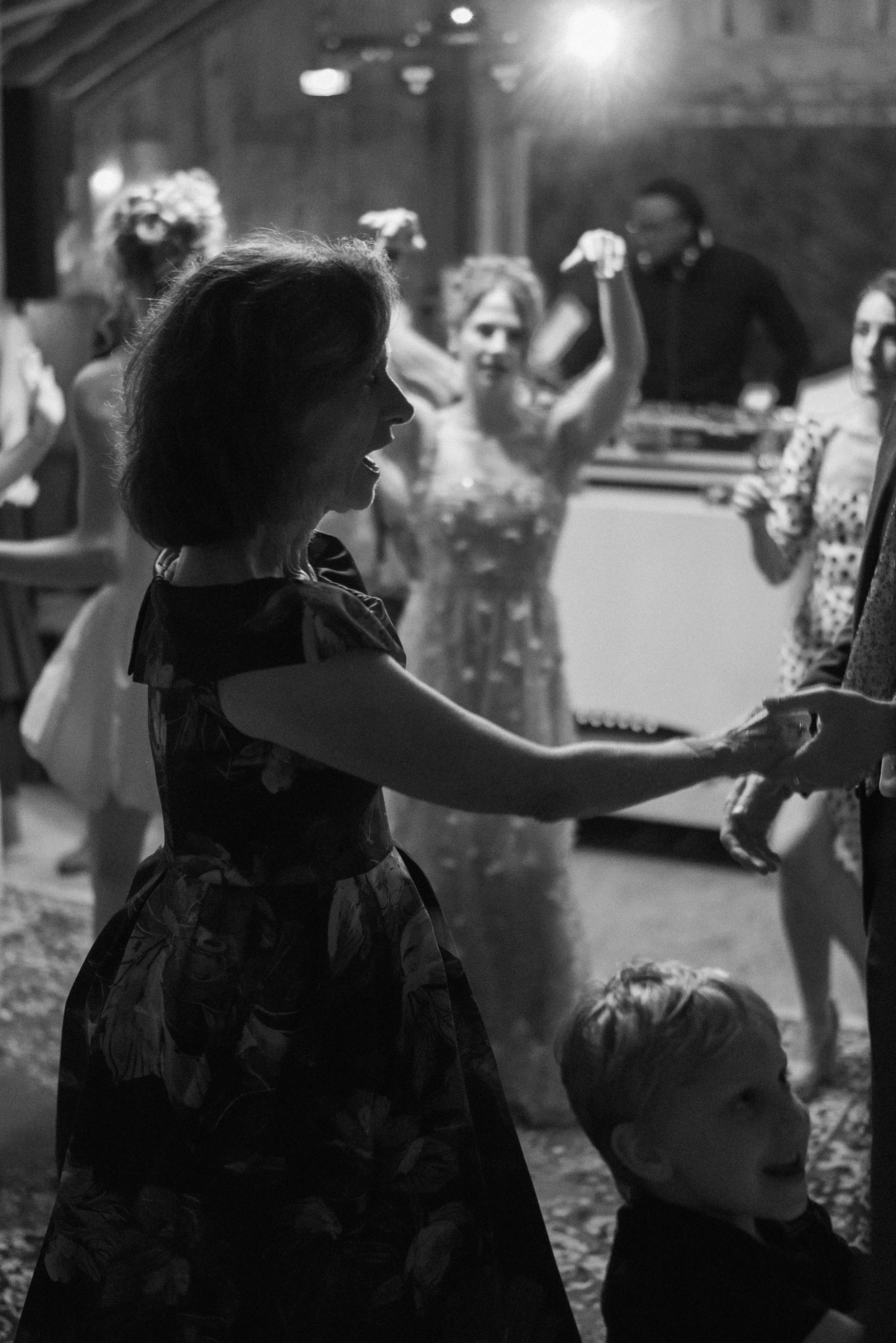 A group of children and an adult dancing and having fun at a party or celebration.