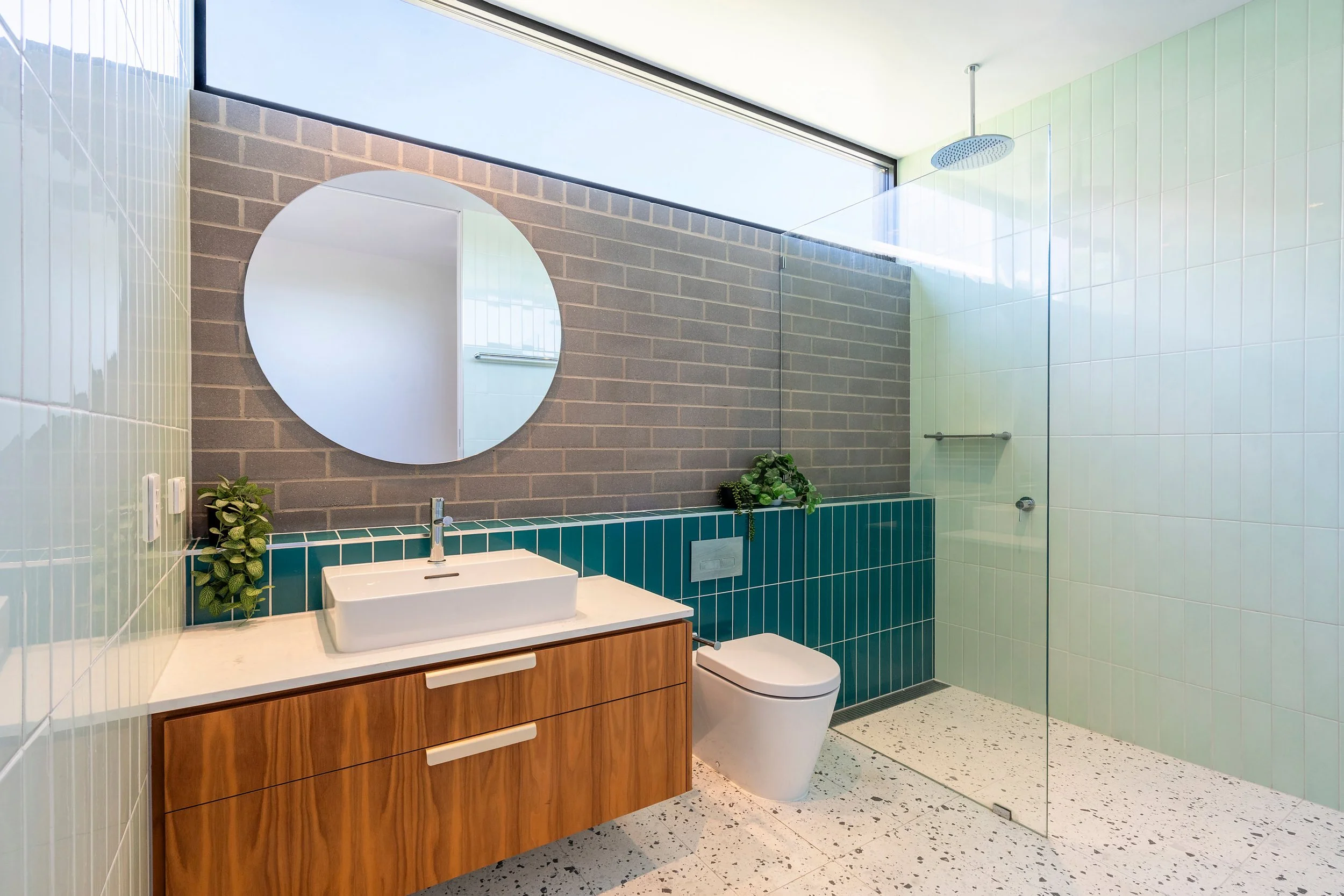 bathroom, teal, aqua, mint green bricks, highlight window, terrazzo, indoor pot plants