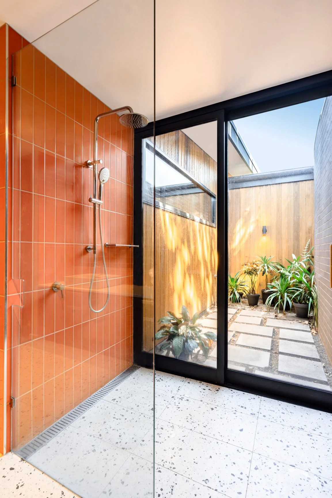 bathroom, shower, orange tiles, terrazzo, private courtyard