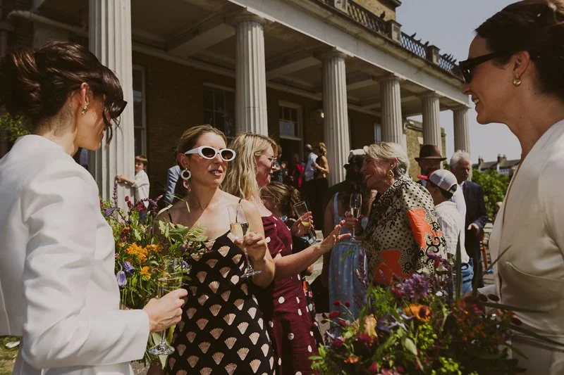 Relaxed documentary wedding photography of couple spending time with guests at intimate London wedding