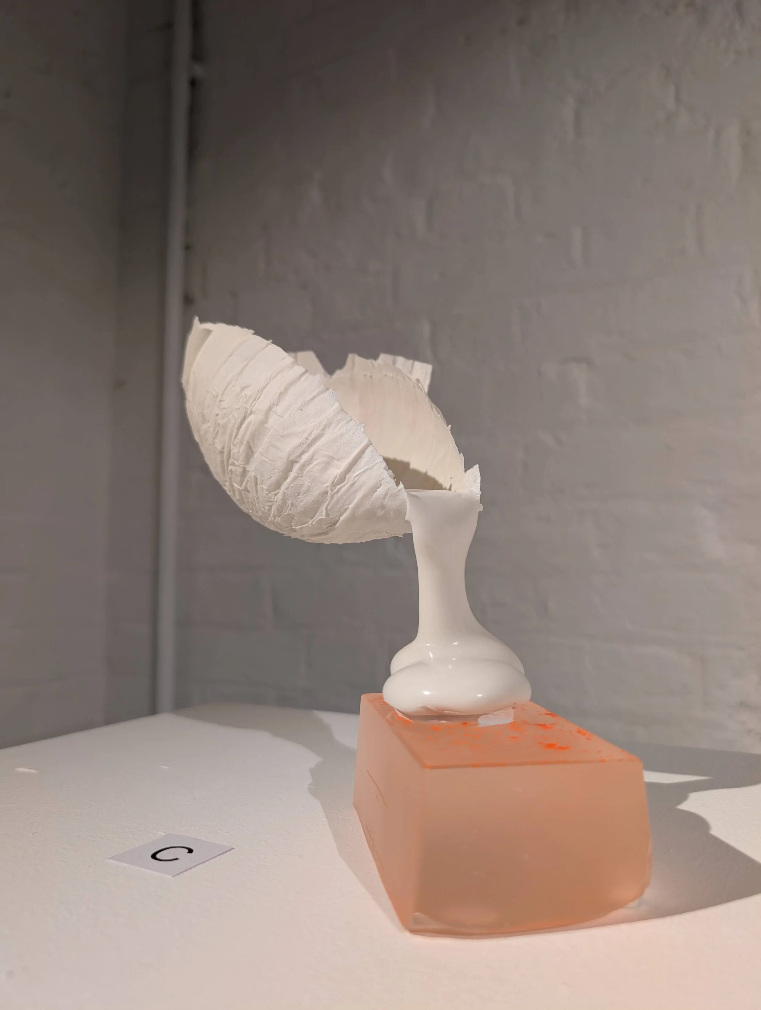 Porcelain form attached to a resin block with white gloop glaze