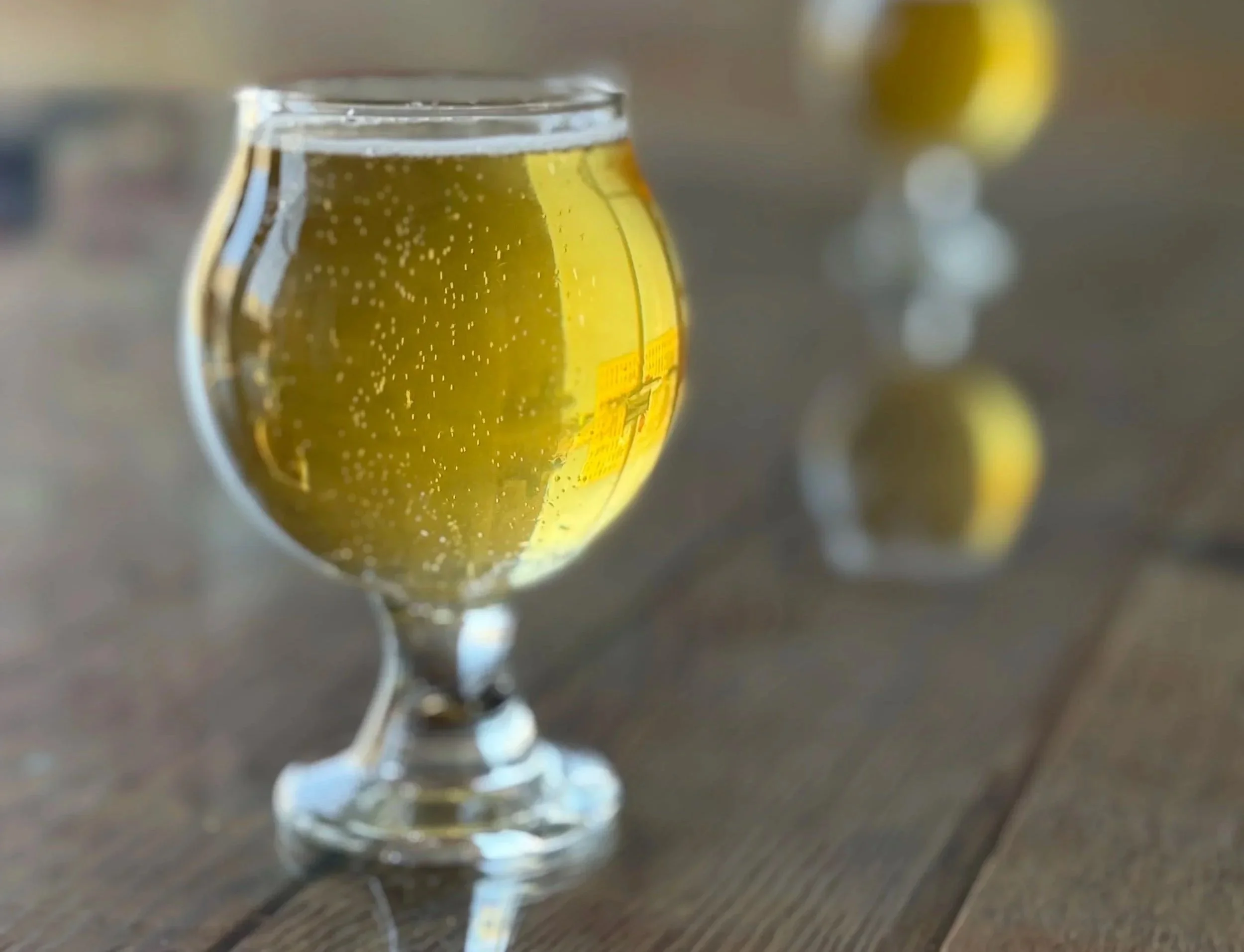 Glass of Deep Here Pilsner from Nicolet Ale Works in De Pere, Wisconsin.