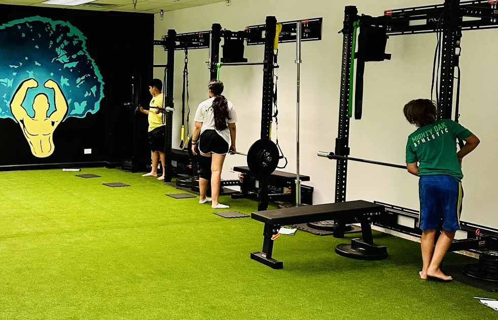 Three middle school kids training at the Mighty Oak Athletic Rogue racks — youth strength training gym in Westmont, IL