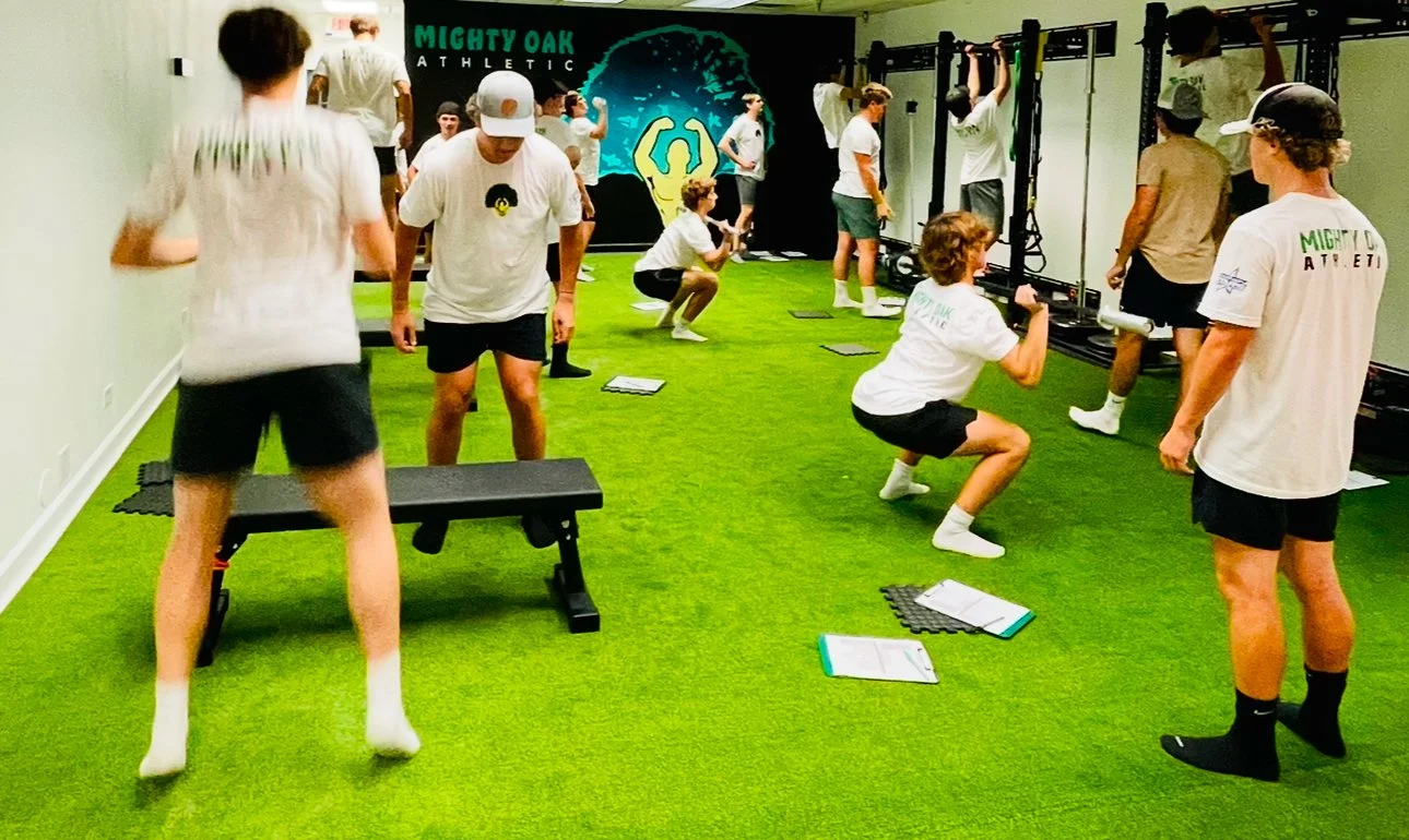 High school athletes training squats and pull-ups at Mighty Oak Athletic in Westmont, Illinois, where academy applicants prepare for the Candidate Fitness Assessment.