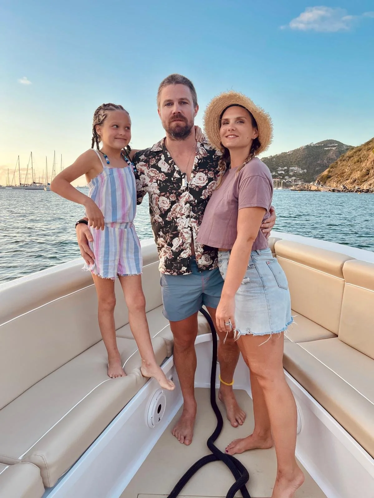 Family gathered on a charter boat deck watching the sun dip into the Caribbean Sea.