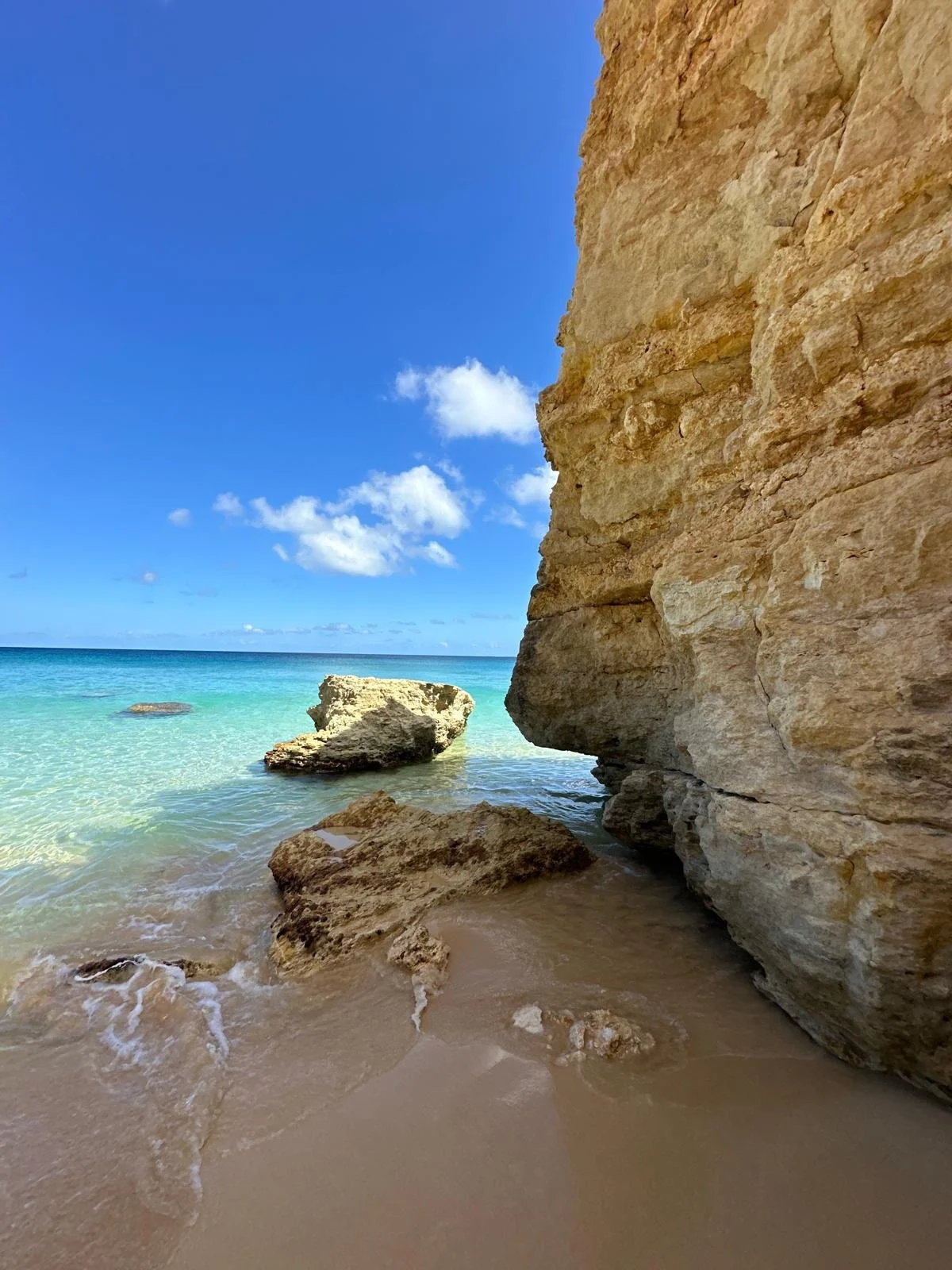 Hidden cliffside beach in Anguilla with turquoise Caribbean water
