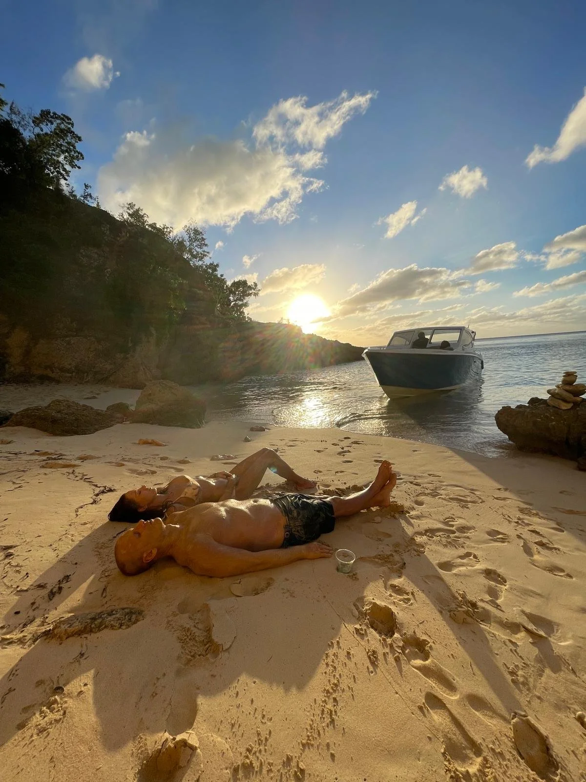 Romantic couple relaxing on a secluded Anguilla beach during a sunset cruise