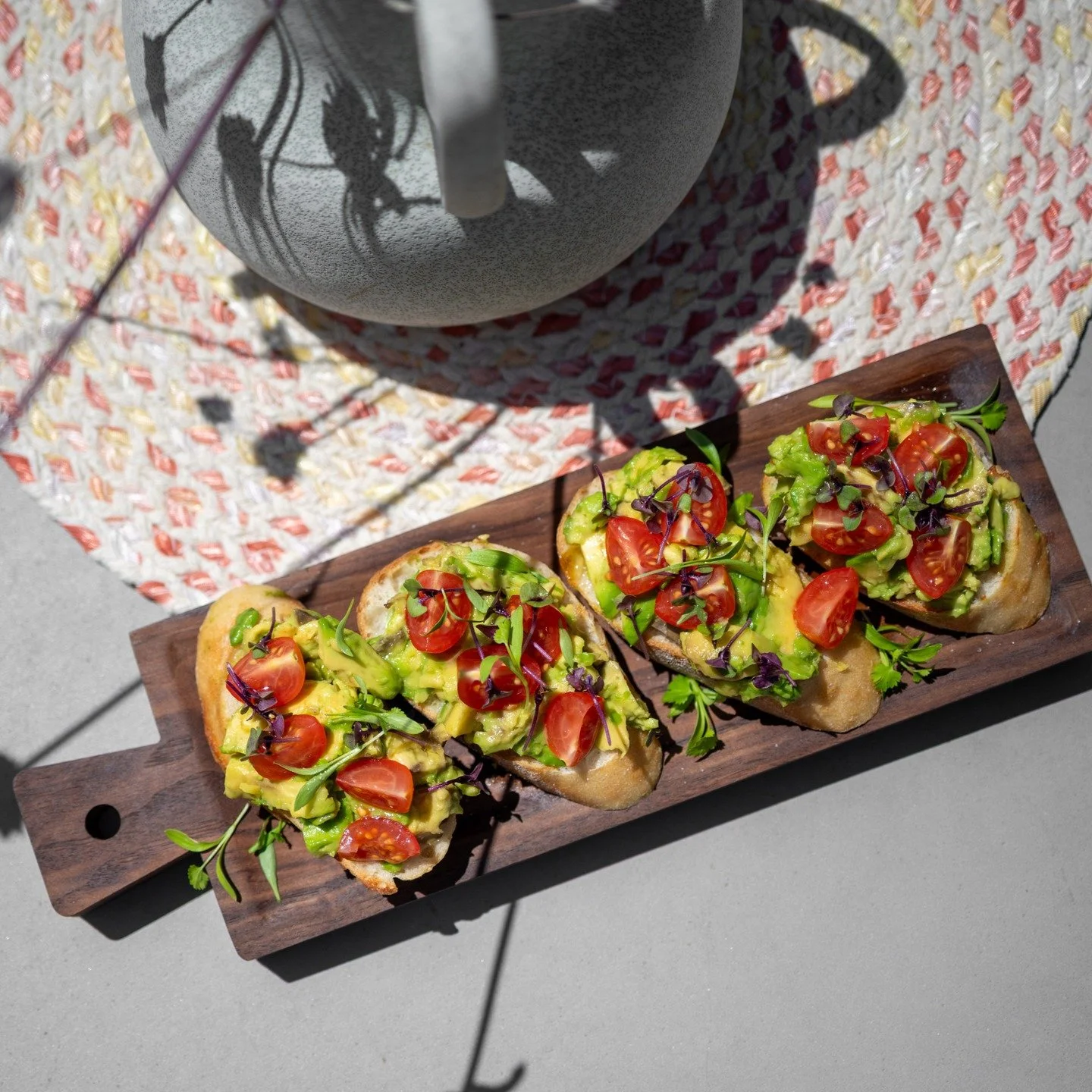 Rustic mornings, fresh flavors 🌿
This country-style avocado toast is topped with smashed avo, sweet cherry tomatoes, microgreens, and a light drizzle of Pamec&rsquo;s own extra virgin olive oil, all served on a wooden board, patio-side.

Simple. Sea