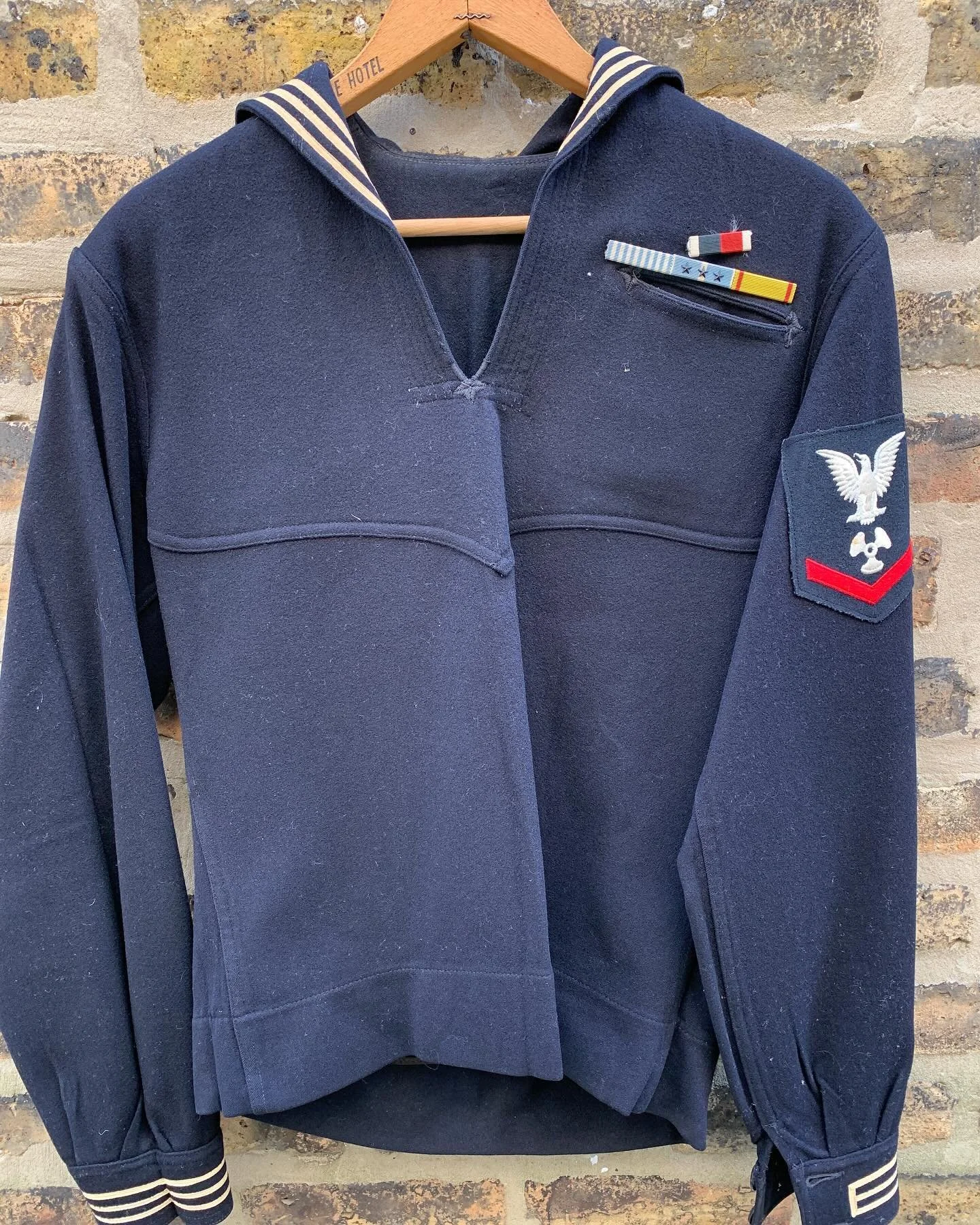 WWII US Navy Cracker Jack Wool Uniform Shirt with the original owner's name still etched into the name tag.