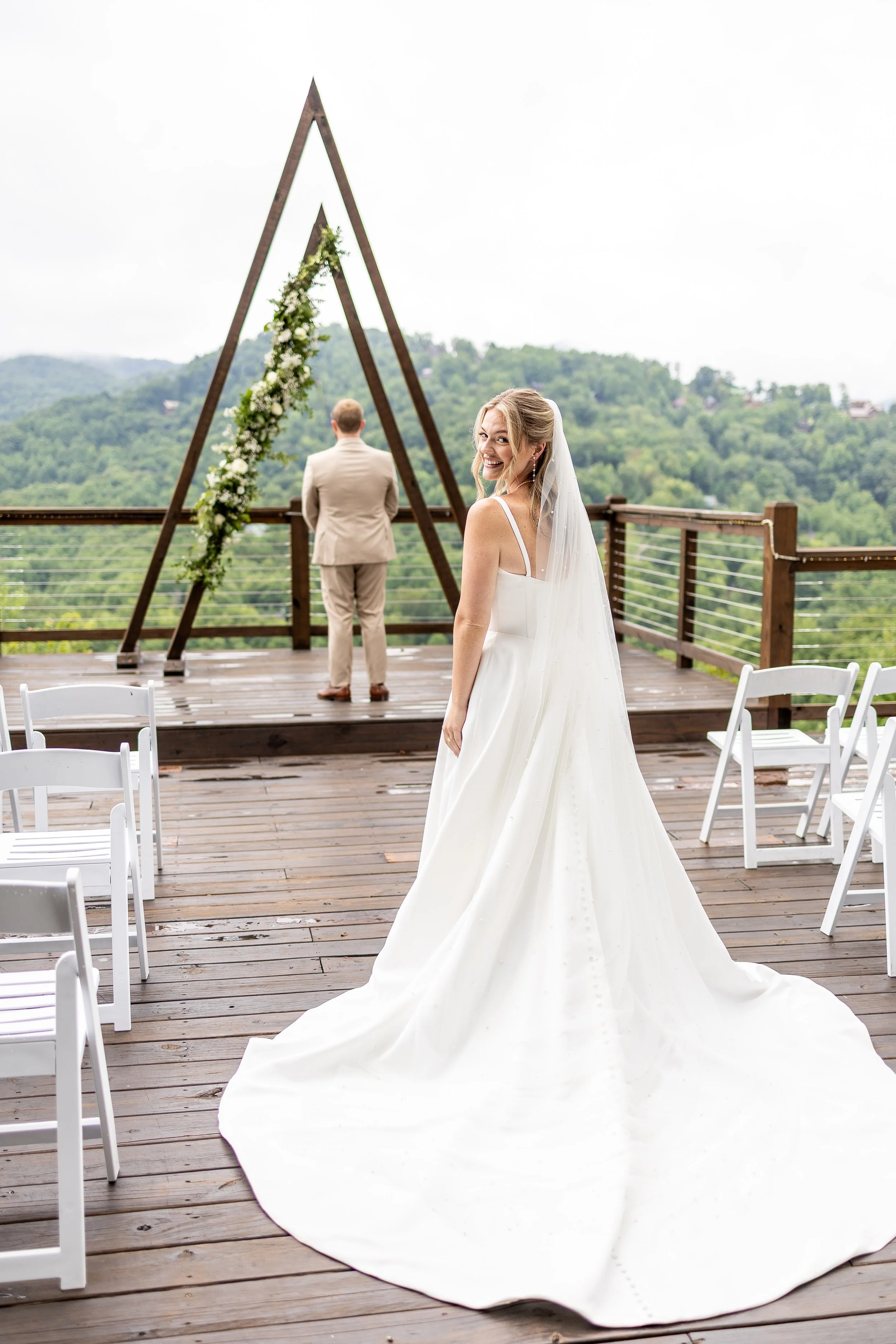 A bride turns around toward the camera getting ready for her first look with her groom.