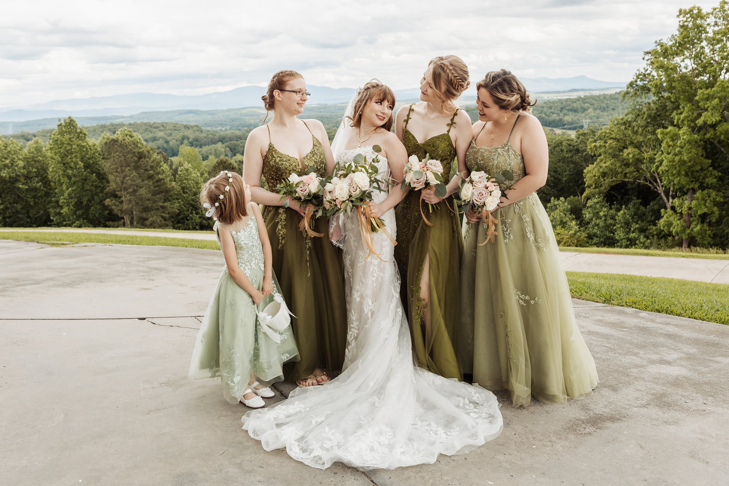 Bridesmaids and the bride is standing on the patio in front of the mountains.